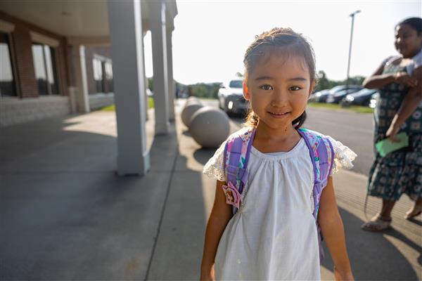 a girl student smiling in the sunshine